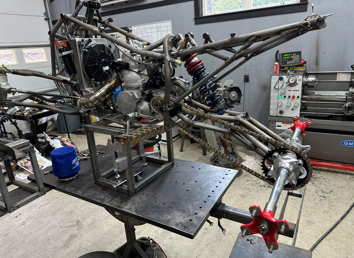 A hybrid race chassis on the fabrication table at the Mechanical Concepts shop